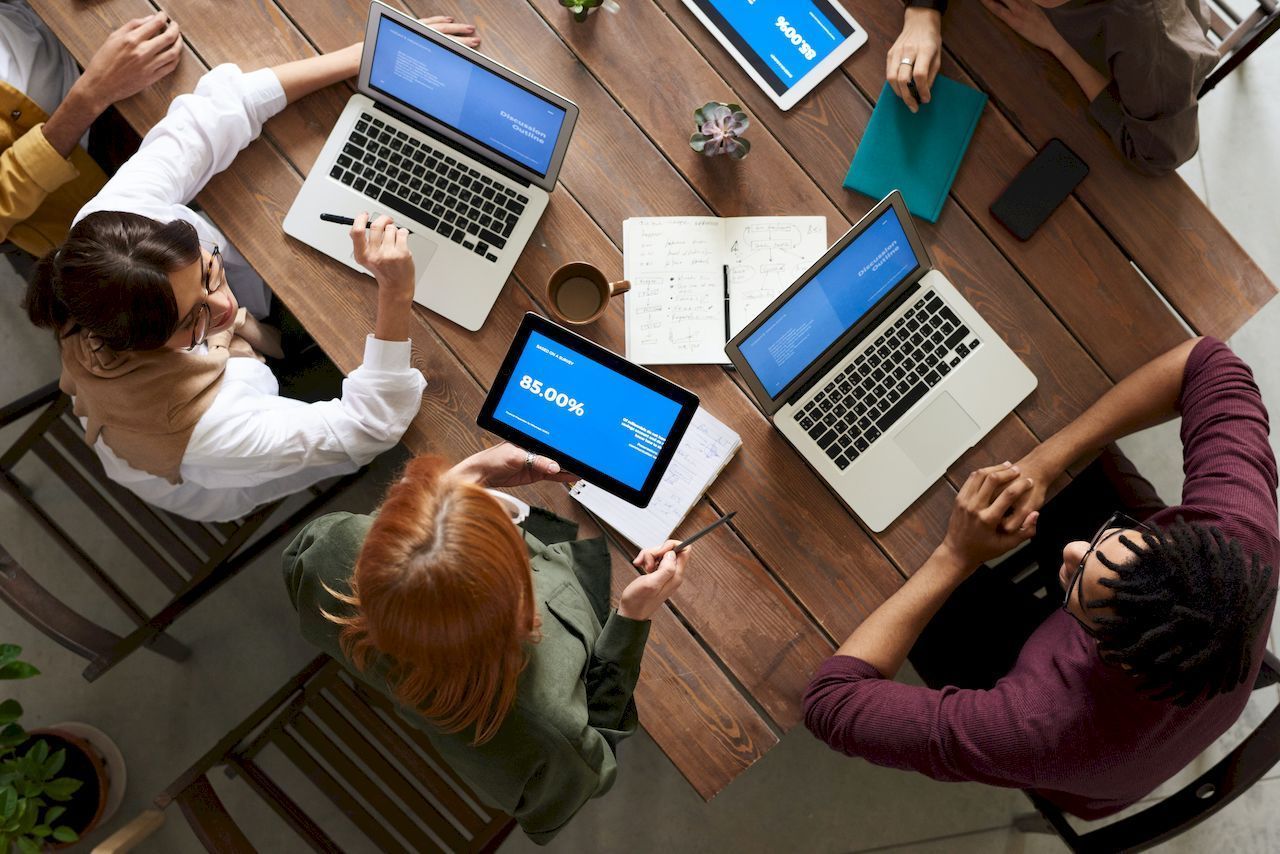 Group working at desk with laptops